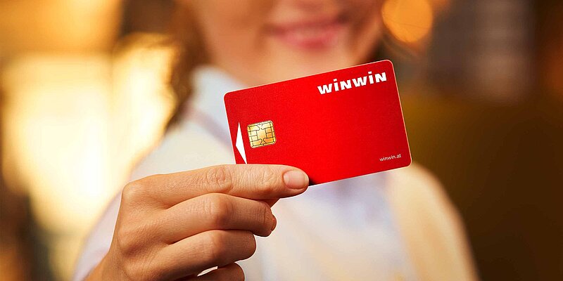 WINWIN-Mitarbeiterin haelt die rote WINWIN-Card.